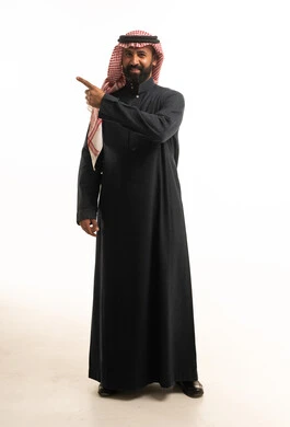 Saudi Man in Traditional Thobe Pointing on White Background