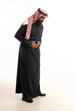 Saudi Man in Traditional Thobe with Stomach Pain