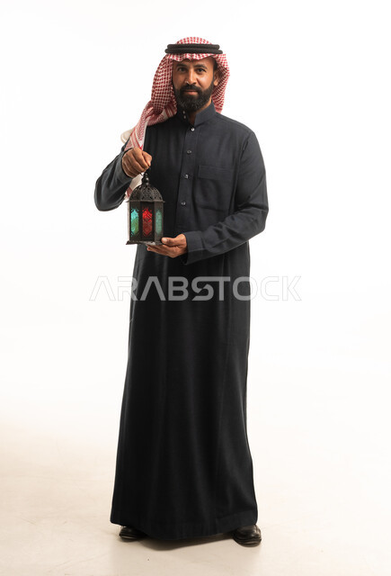 Saudi Man in Traditional Thobe Holding Ramadan Lantern