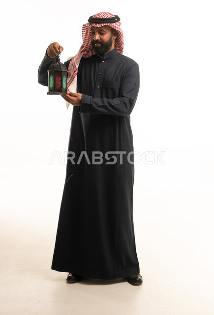 Saudi Man in Black Thobe Holding Ramadan Lantern