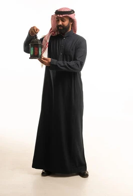 Saudi Man in Black Thobe Holding Ramadan Lantern