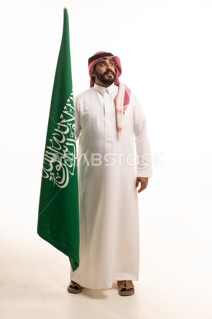 Saudi Man Holding National Flag in Traditional Clothing