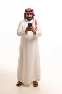 Saudi Man in Traditional Thobe Using Smartphone Studio