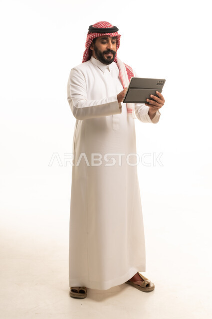 Saudi Man Using Digital Tablet on White Background