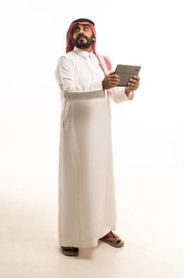Saudi Man in Traditional Thobe Holding Digital Tablet