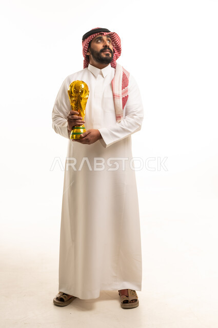 Saudi Man in Traditional Thobe Holding Gold Trophy