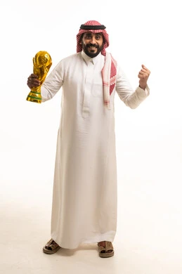 Saudi Man Holding Gold Football Trophy in Studio
