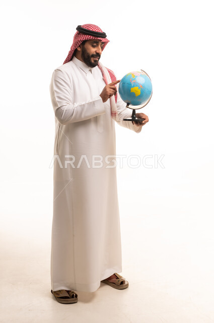 Saudi Man in Traditional Dress Holding a World Globe