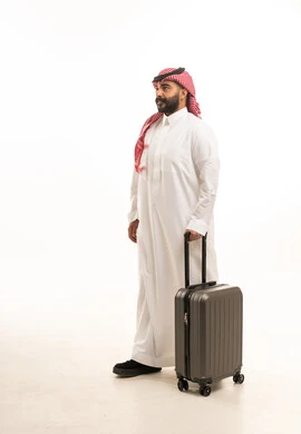 Saudi Man in Traditional Thobe with Travel Suitcase