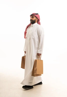 Saudi Man in Traditional Dress with Shopping Bags