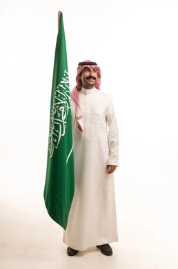 Saudi Man Holding National Flag on White Background