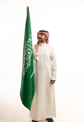 Saudi Man Holding National Flag on White Background