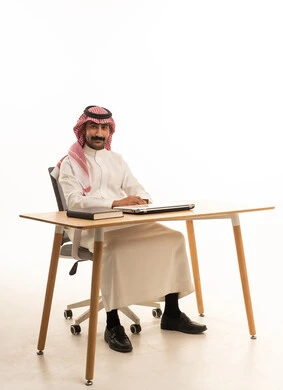 Saudi Man in Traditional Thobe at Office Desk