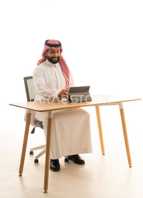Saudi Man Using Tablet at Desk on White Background