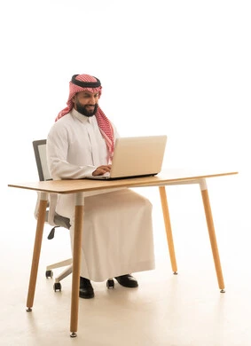 Saudi Businessman Working on Laptop at Modern Desk