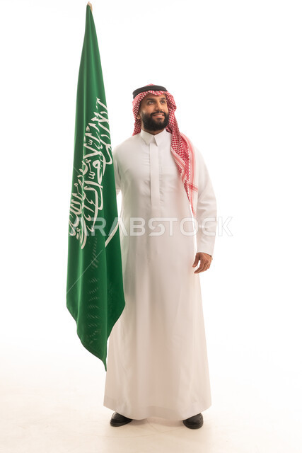Saudi Man Holding Saudi Arabia Flag in Traditional Dress
