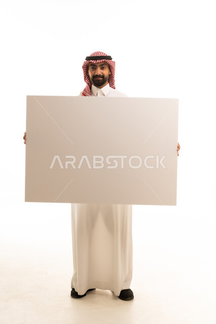 Saudi Man Holding Blank White Board in Traditional Dress
