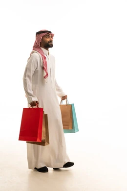 Saudi Man in Traditional Dress Carrying Shopping Bags