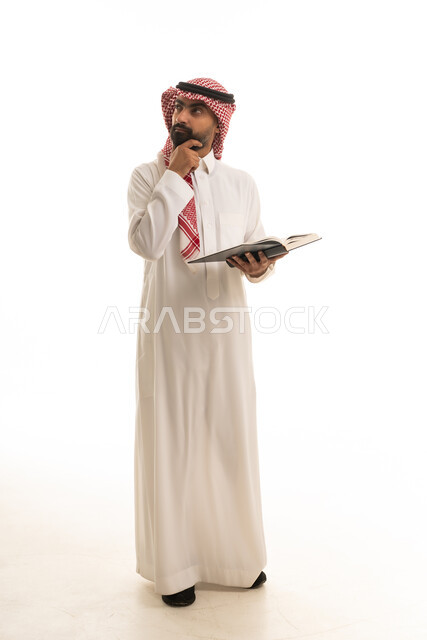 Saudi Man in Traditional Thobe Reading Book