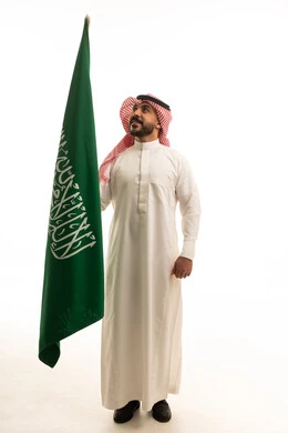 Saudi Man Holding National Flag on White Background