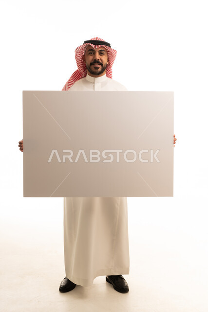 Saudi Man in Traditional Thobe Holding Blank White Board