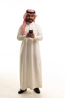 Saudi Man in Traditional Dress Using Smartphone