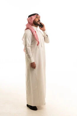 Saudi Man in Traditional Thobe Talking on Mobile Phone