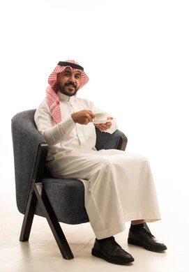 Saudi Man in Traditional Dress Holding Cup