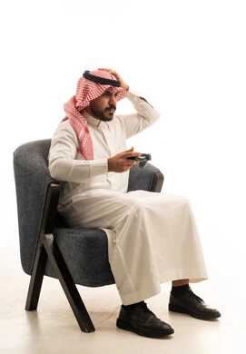 Saudi Man Gaming and Frustrated in Armchair