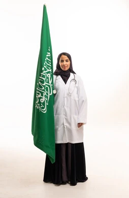 Saudi Female Doctor Holding Saudi Flag in Lab Coat