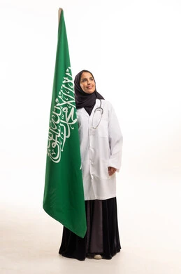 Saudi Female Doctor Standing with Saudi National Flag