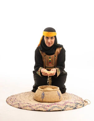 Saudi Woman in Traditional Southern Dress with Wheat
