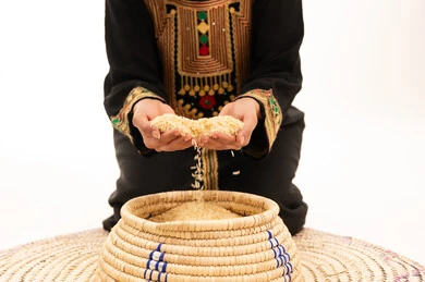 Traditional Saudi Dress and Rice in Woven Saff Basket