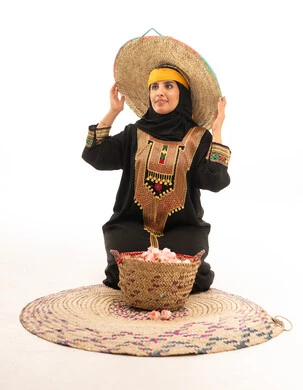 Saudi Woman in Traditional Southern Attire with Roses