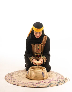 Saudi Woman in Traditional Heritage Dress with Woven Basket