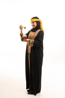 Emirati Woman in Traditional Dress Holding Honey Jar