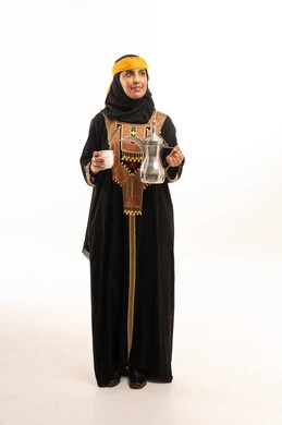 Saudi Woman in Traditional Dress with Arabic Coffee Pot