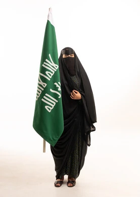 Saudi Arabian Woman in Niqab Holding National Flag