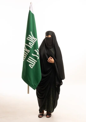 Saudi Woman Holding Saudi Flag in Studio