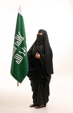 Saudi Woman in Traditional Abaya with National Flag