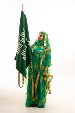 Saudi Woman Holding National Flag in Traditional Dress