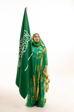 Saudi Woman in Traditional Green Dress with National Flag