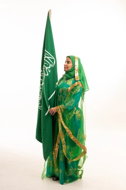 Saudi Woman in Traditional Dress Holding Saudi Flag