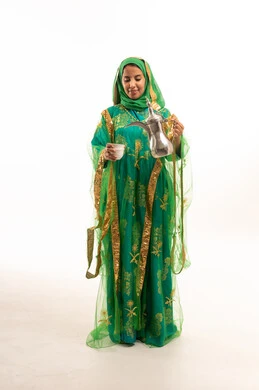 Saudi Woman in Traditional Green Dress Holding Dallah