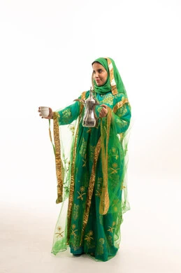 Saudi Woman in Traditional Green Dress with Dallah