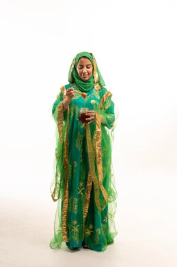 Saudi Woman in Green Traditional Dress Holding Honey Jar