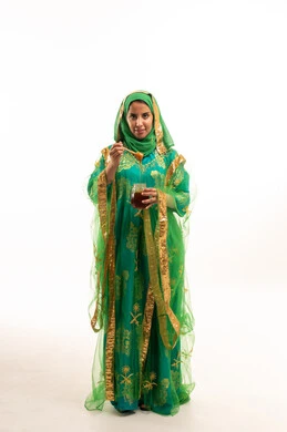 Saudi Woman in Traditional Green Dress Holding Honey Jar