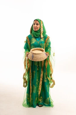 Saudi Woman in Traditional Green Dress with Basket