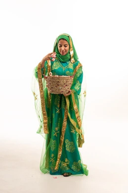 Saudi Woman in Traditional Green Nashal Dress with Basket