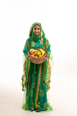 Saudi Woman in Traditional Green Dress with Fruit Basket